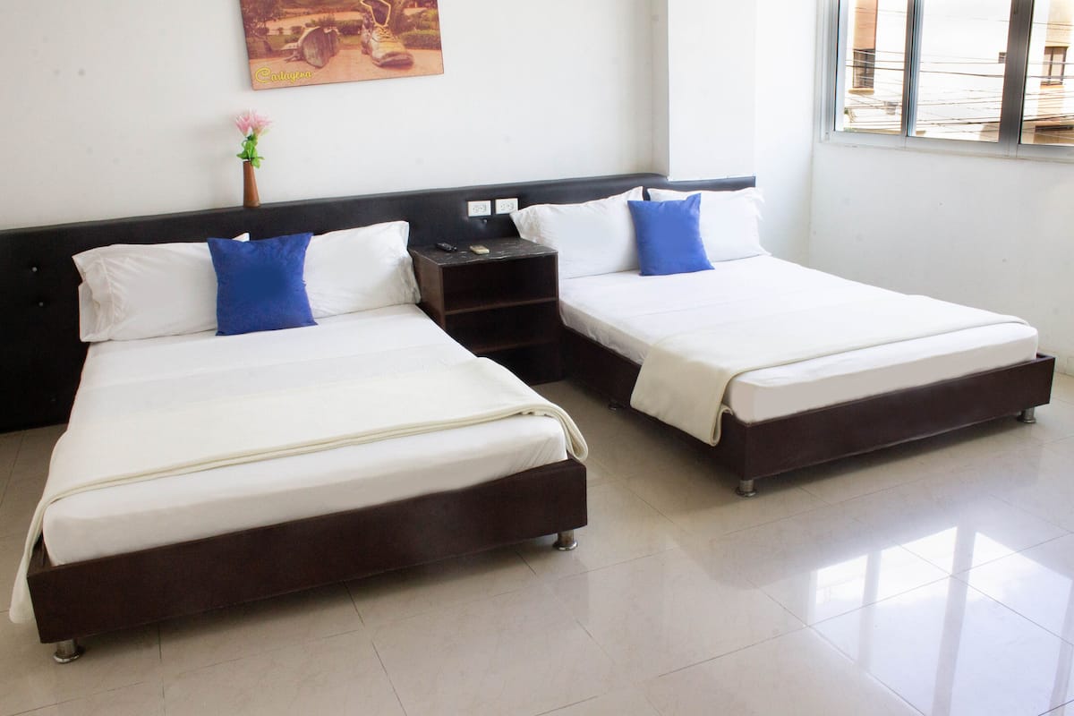 Standard Triple Room | Minibar, in-room safe, iron/ironing board, bed sheets