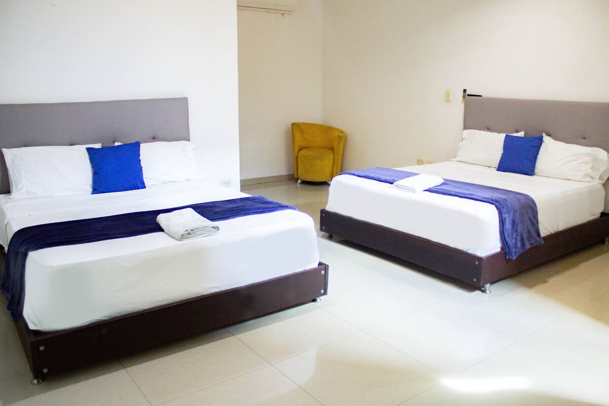 Family Room | Minibar, in-room safe, iron/ironing board (on request), bed sheets