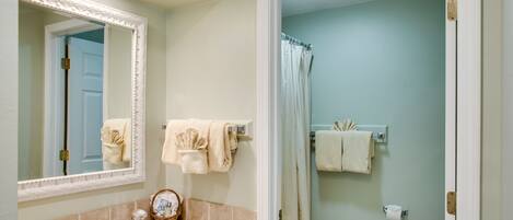 A bathroom with a sink, mirror, and toilet.