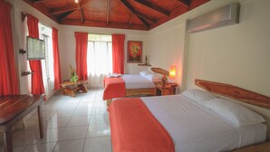 A hotel room with two beds, a wooden table, a TV, and a window with curtains. - Hotel Cerro Lodge (Lagunillas)