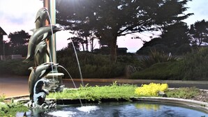A fountain with two dolphins and a water spout. - Emerald Dolphin Inn & Mini Golf (Fort Bragg)