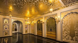 A spacious, well-lit hallway with ornate wall decorations and a polished floor.