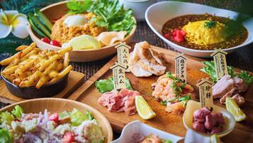 A variety of dishes including seafood, fried items, and salads, arranged on a wooden table.