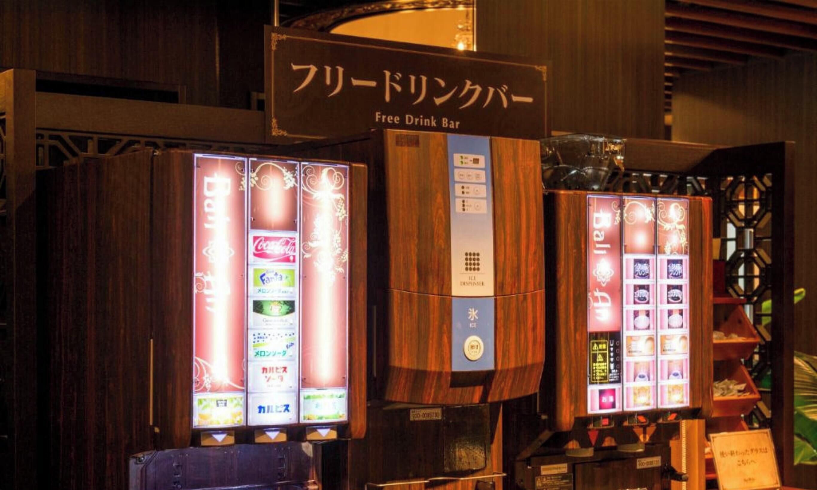 A free drink bar with vending machines displaying various beverages.