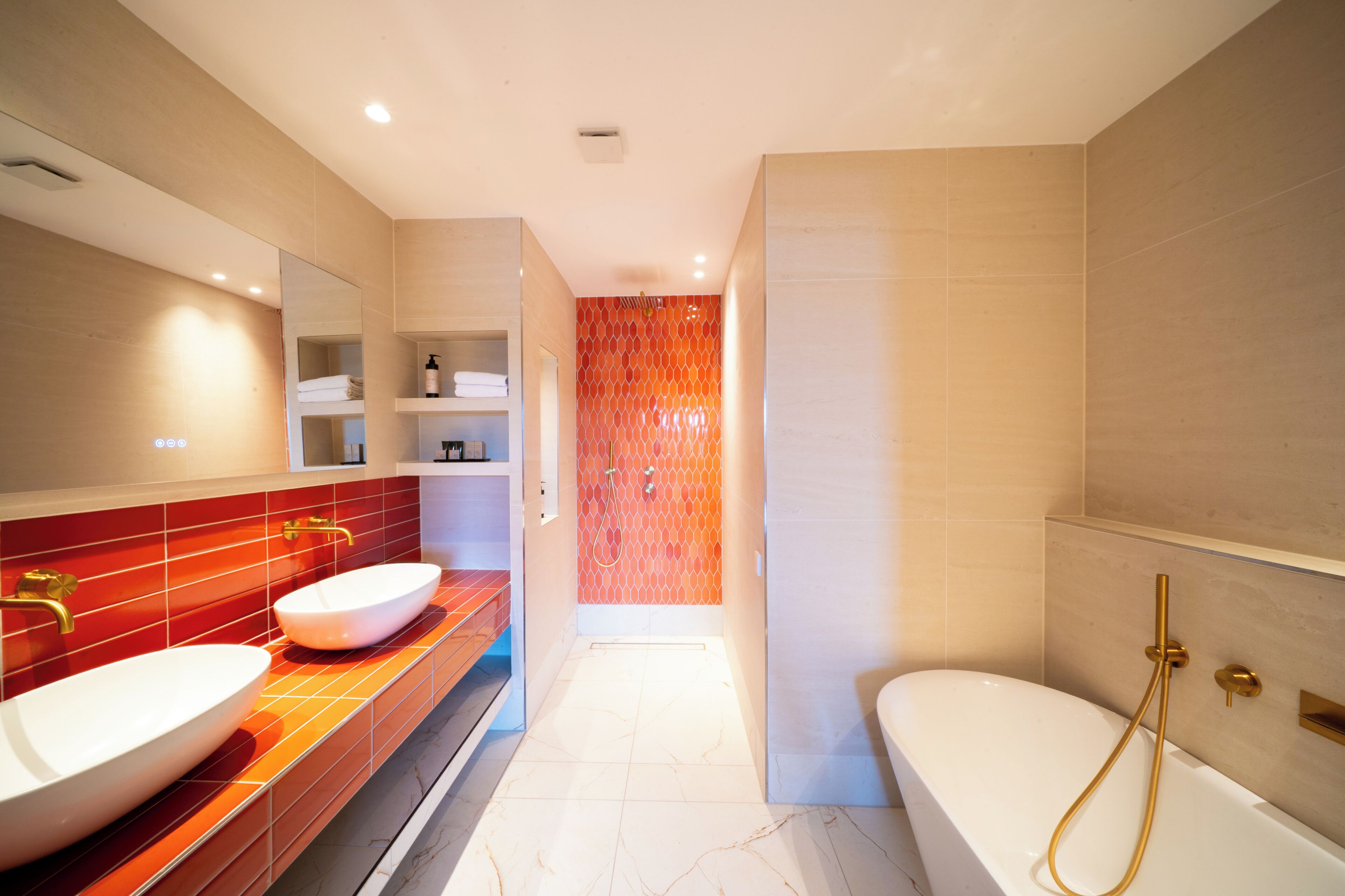 A modern bathroom with two sinks, a bathtub, and a shower.