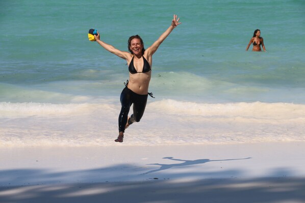 On the beach, white sand, sun-loungers
