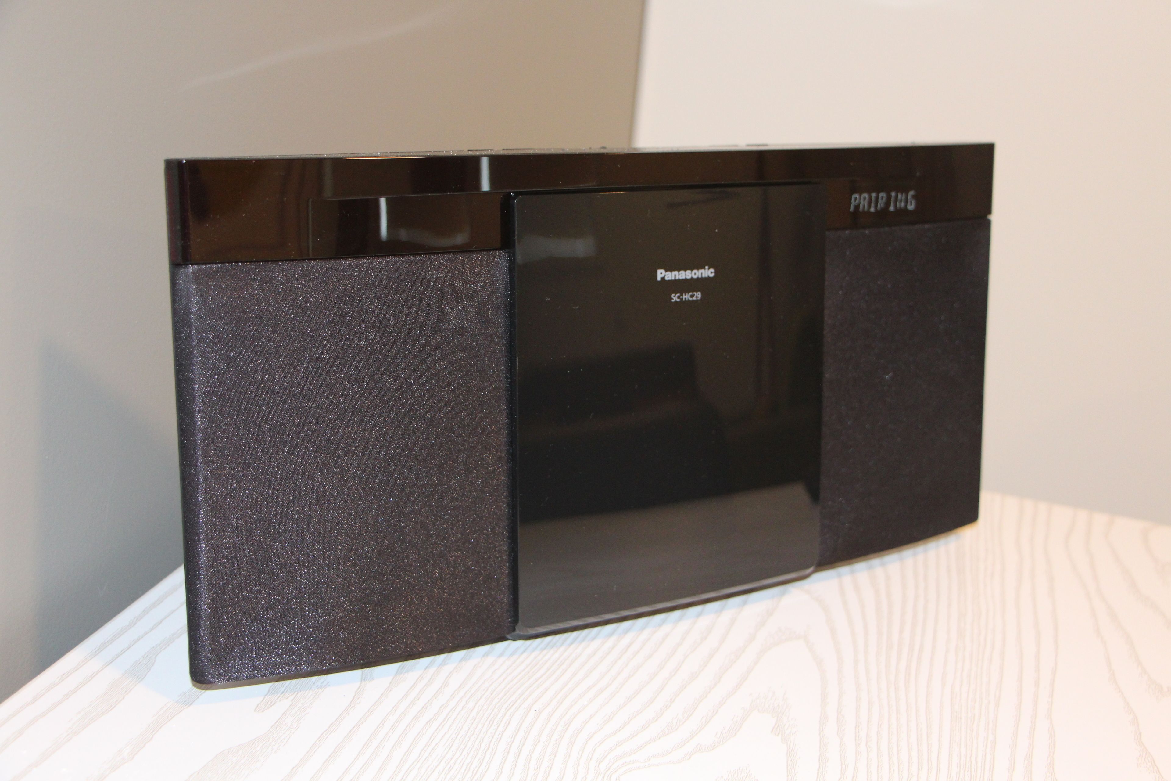 A Panasonic SC-HC29 microwave on a wooden surface.