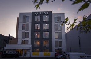 A building with the sign "QUEST" at the top, featuring multiple windows and a modern architectural design. - Quest Nelson (Nelson)