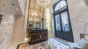A luxurious lobby with marble floors, a grand chandelier, and a large ornate mirror. - Arcade Hotel (Istanbul)