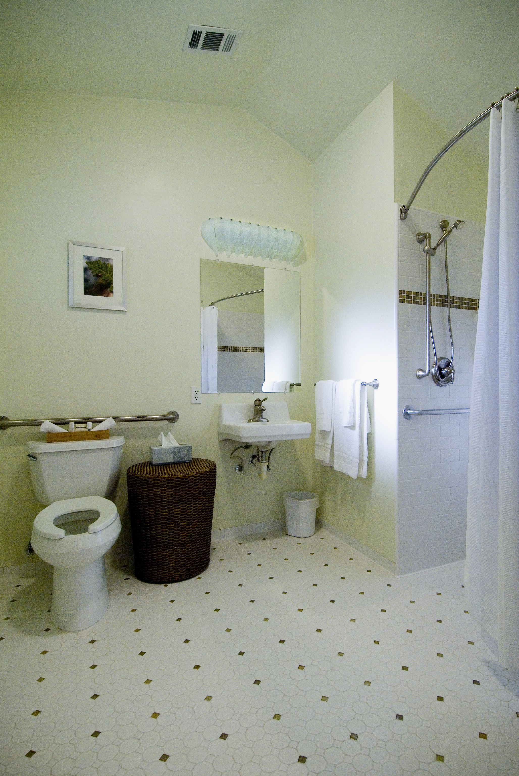 A bathroom with a toilet, sink, and shower.
