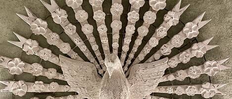 A detailed, symmetrical floral pattern on a textured wall.