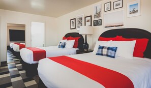 A hotel room with two beds, each with red and white bedding, a checkered floor, and framed pictures on the wall. - LiA Hotel (San Carlos)