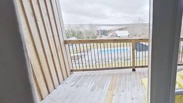 Enjoy the serene pool views from this balcony.