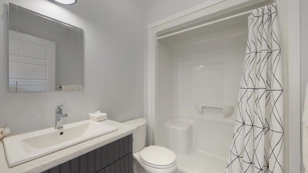 Un baño con lavamanos, inodoro y ducha.