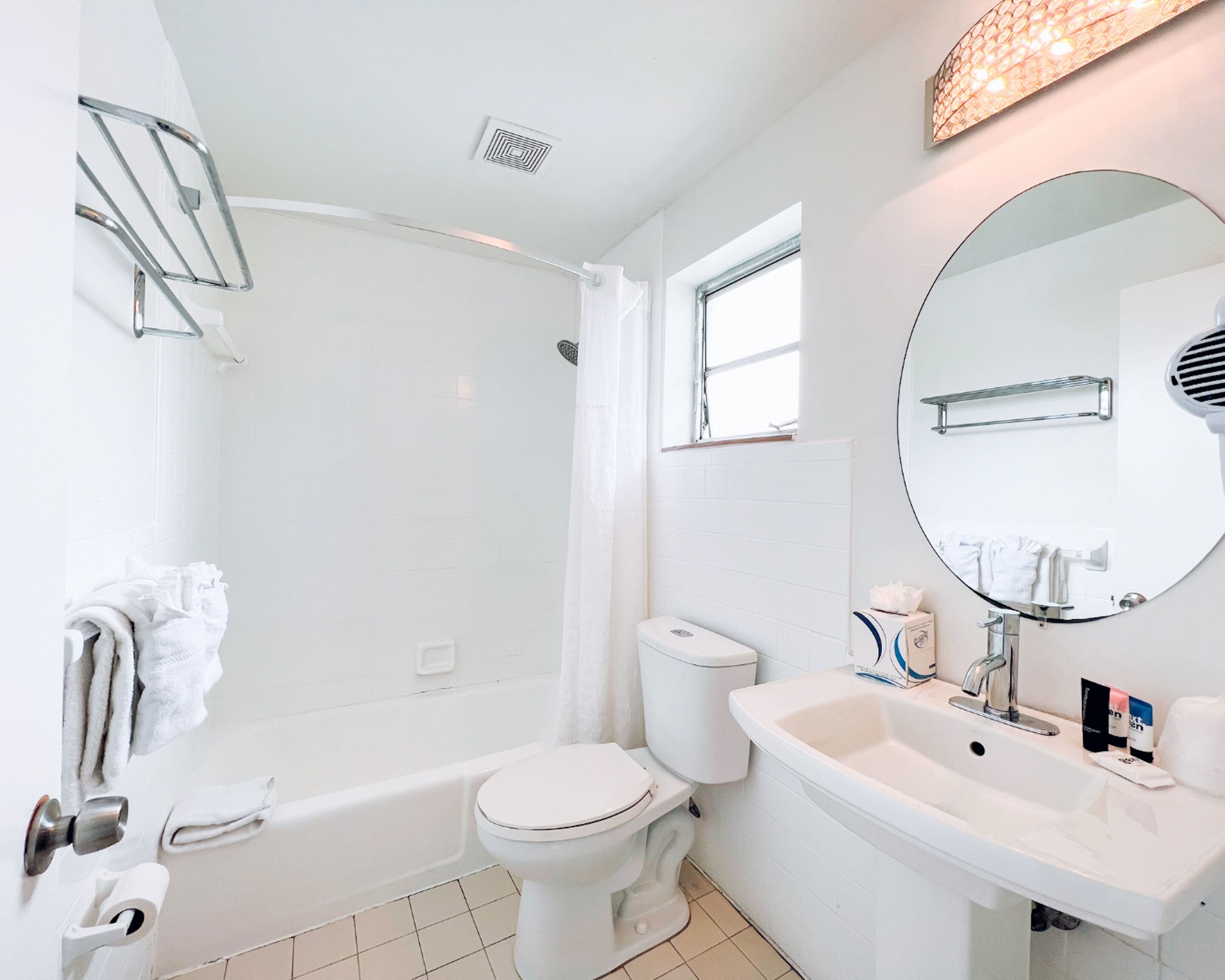 A modern bathroom with a bathtub, toilet, and sink.