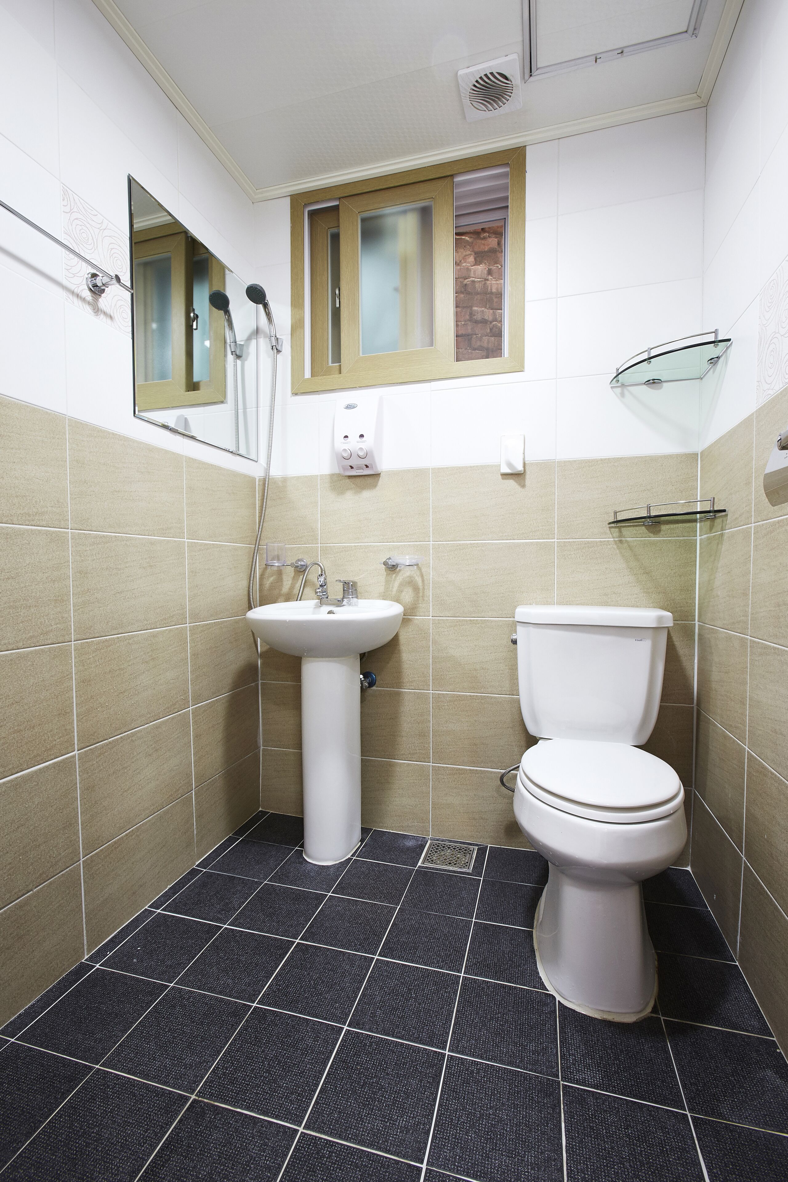 A bathroom with a sink, toilet, and a shower.
