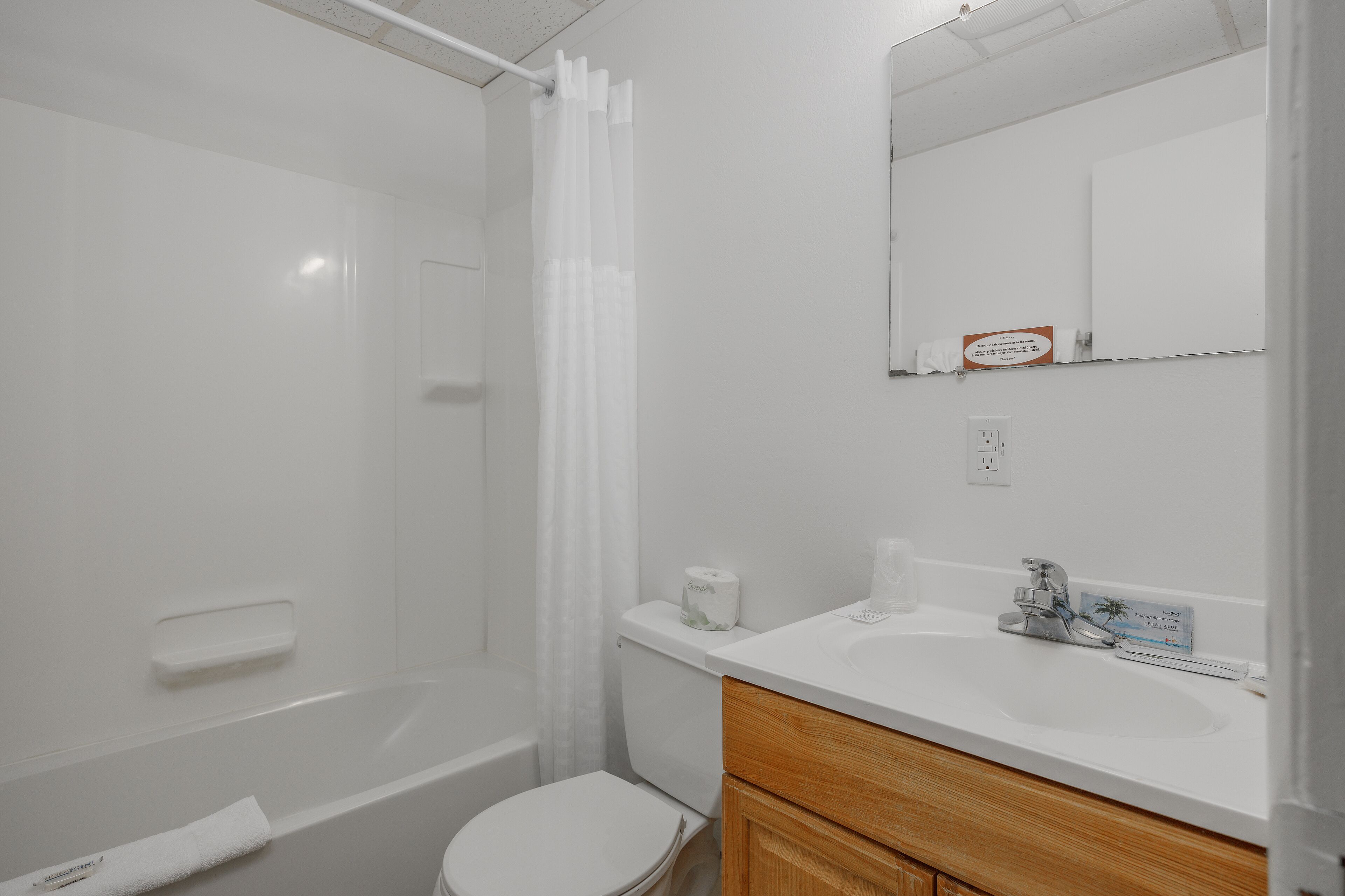 A bathroom with a bathtub, toilet, and sink.