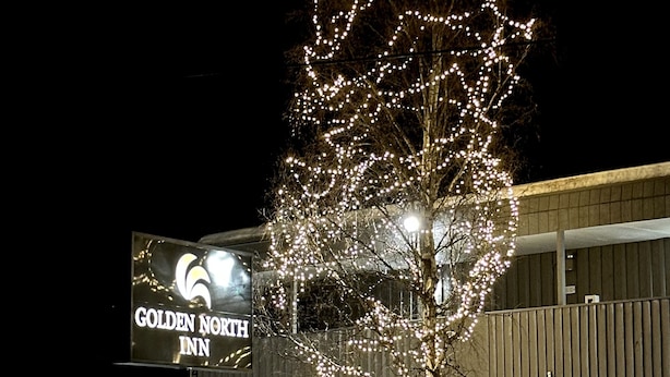 A tree decorated with lights in front of the Golden North Inn. - Golden North Inn (Fairbanks)