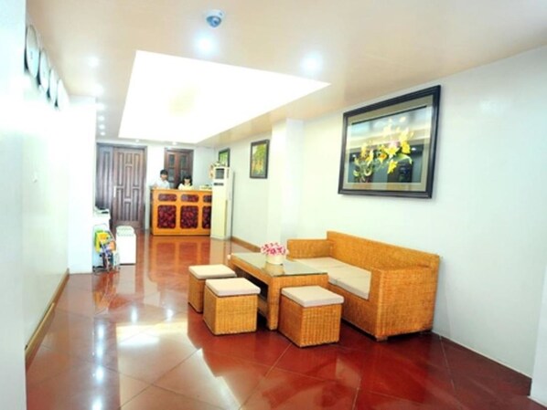A reception area with a reception desk, a sofa, and a coffee table.