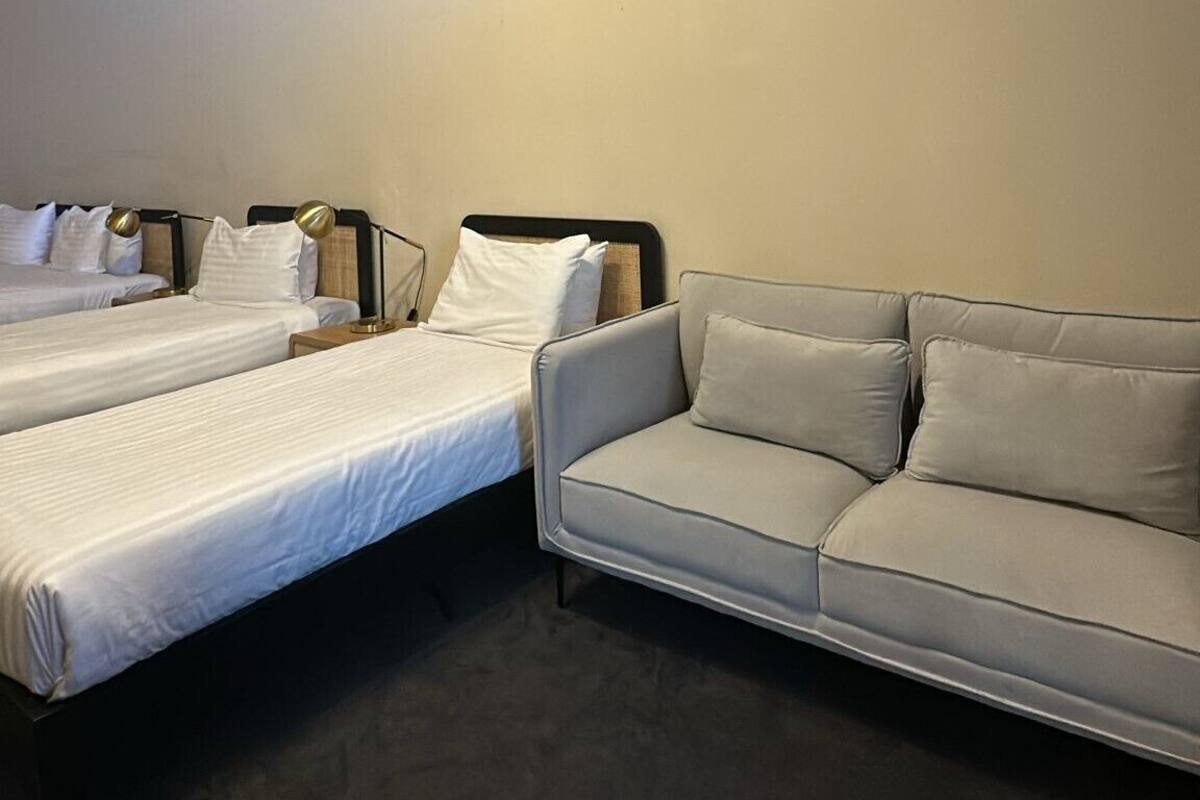 Standard Quadruple Room | Living area | Flat-screen TV