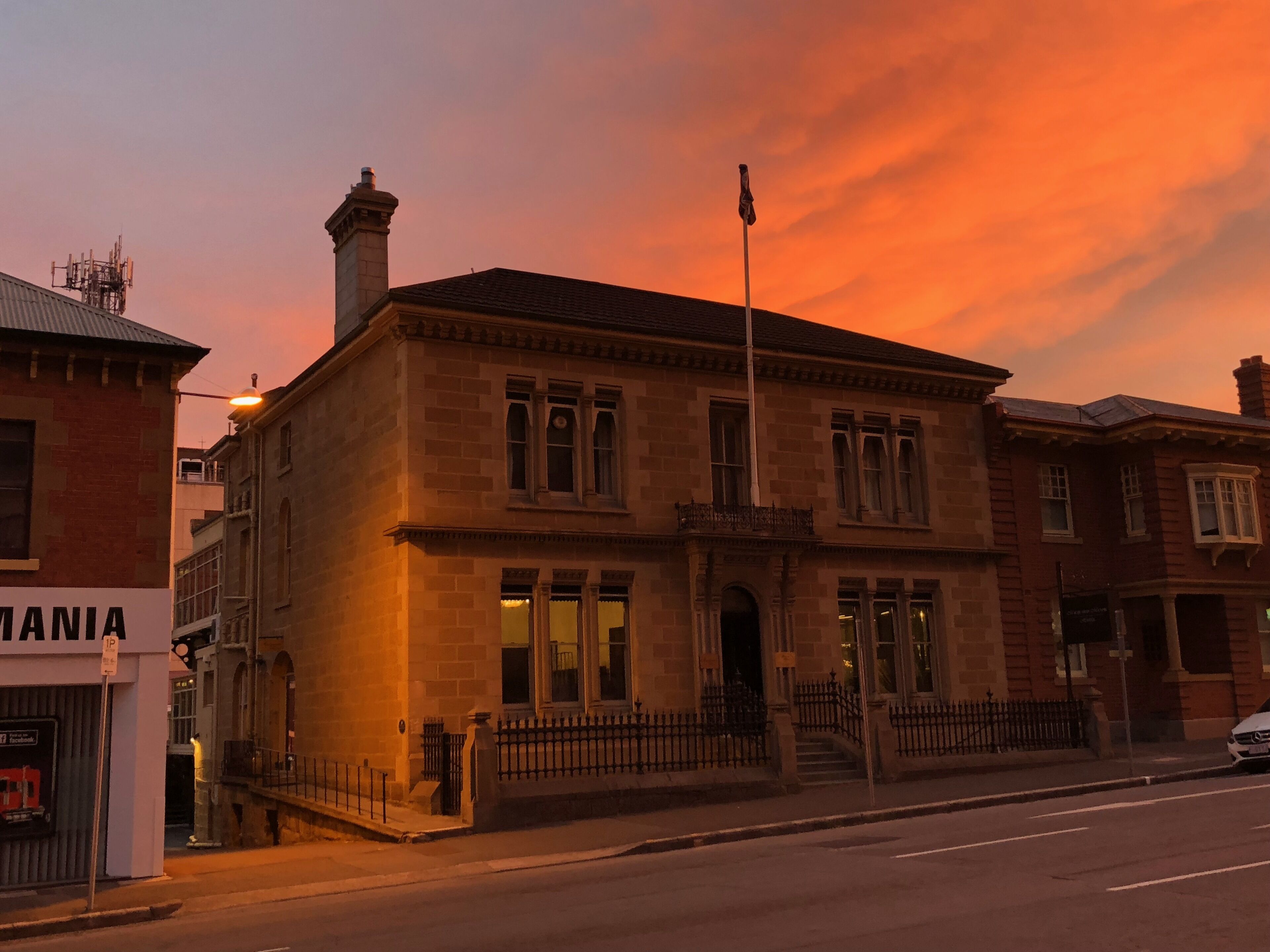 A historic building with a symmetrical facade, large windows, and a central entrance.