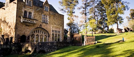 A historic stone building with arched windows and a sign that reads "WATFORD".