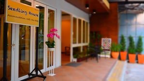 A sign for Seedling House, indicating it offers accommodation, cafe, and an eco shop.