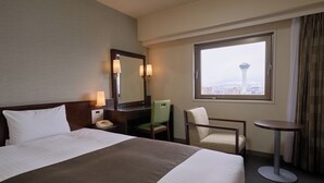 A hotel room with a bed, a desk, a chair, a small table, a mirror, and a window with a city view. - Hotel Hokke Club Hakodate (Hakodate)