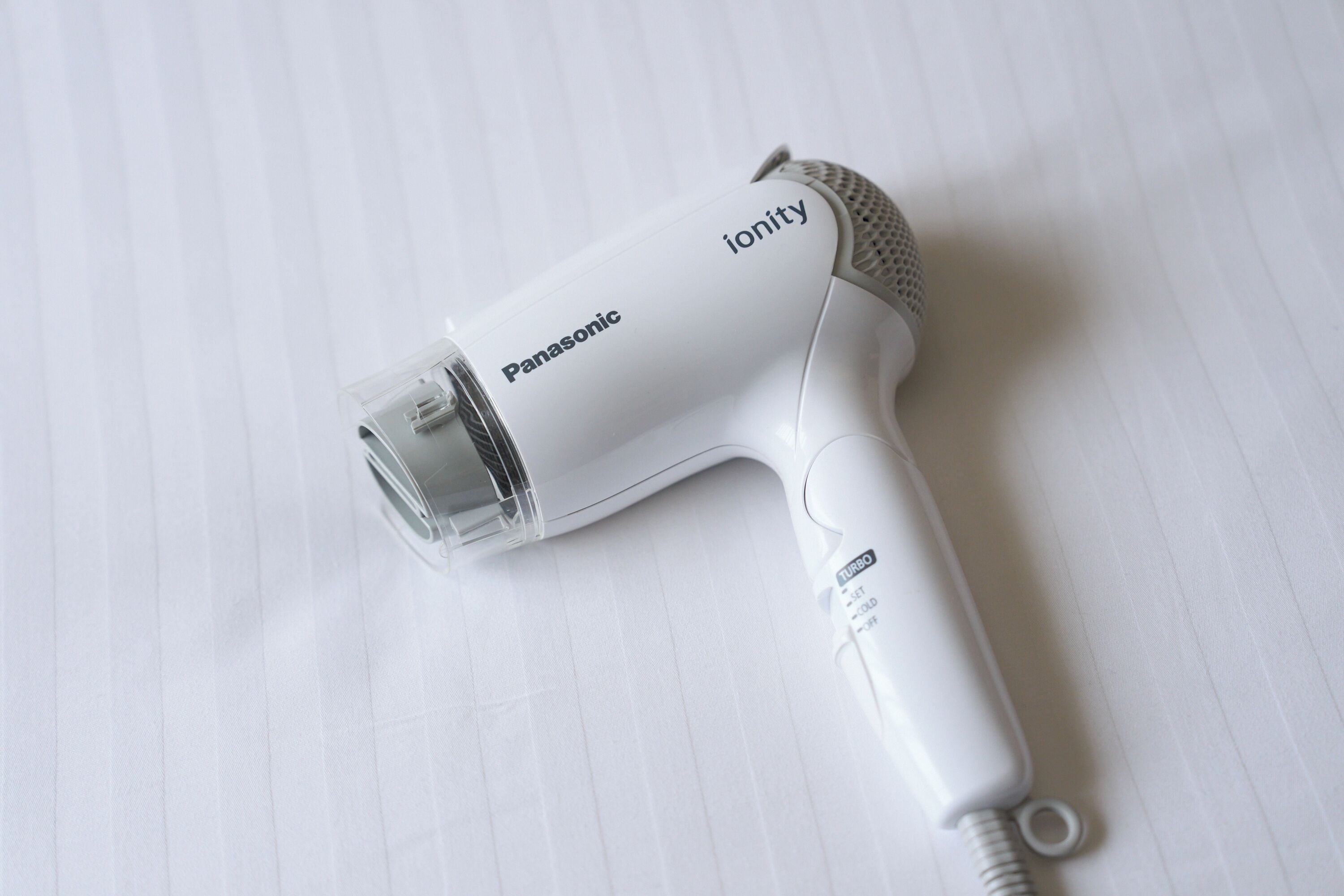 A Panasonic ionity hair dryer on a white surface.