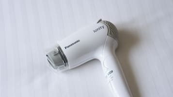A Panasonic ionity hair dryer on a white surface.
