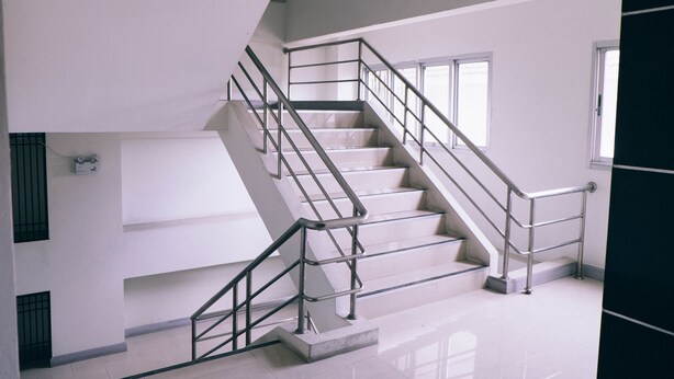 A staircase with metal railings and a tiled floor. - Golden On-nut (Bangkok)