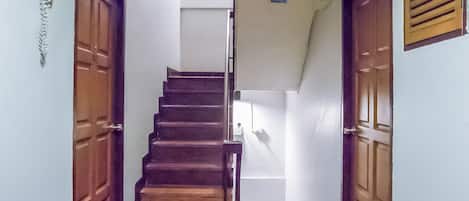 A staircase with wooden steps leading to a landing.