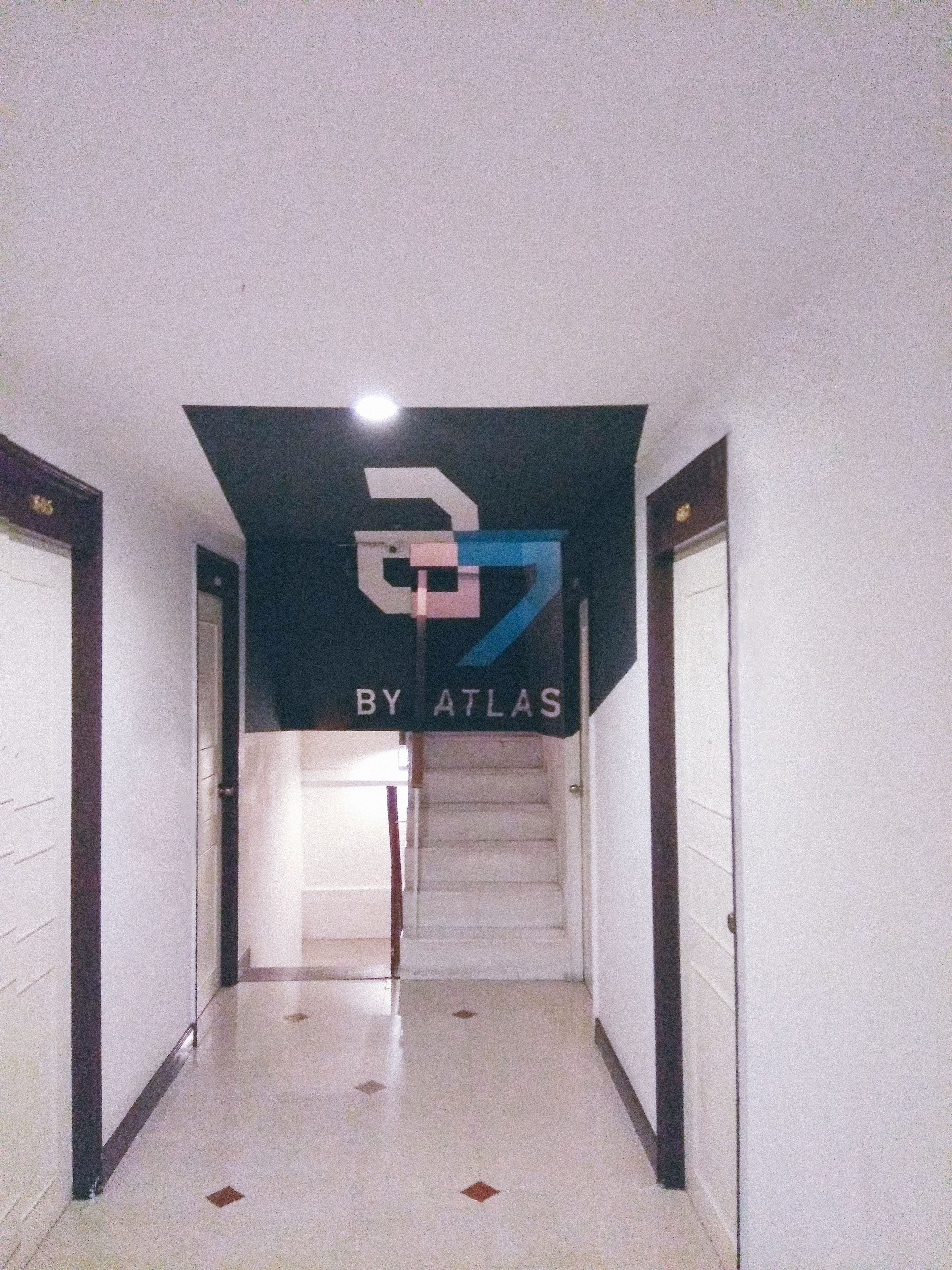A hallway with a staircase leading to a door marked "505".