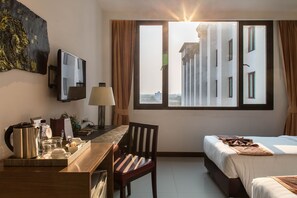Enjoy a view of the city from the large window, relax on the comfortable bed, and stay entertained with the flat-screen TV.