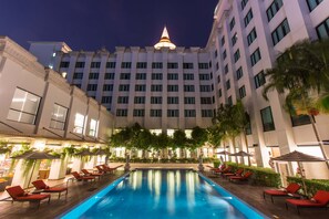Relax by the pool surrounded by lounge chairs and umbrellas in our tranquil courtyard.