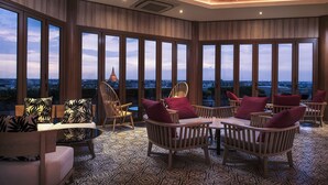 A spacious room with large windows, wooden furniture, and a patterned floor. - Mida Grande Hotel Dhavaravati, Nakhon Pathom (Nakhon Pathom)