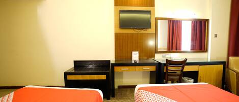 A hotel room with two beds, a desk, a chair, a TV, and a mirror.
