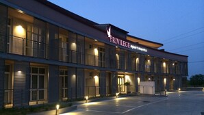A modern building with a sign reading "PRIVILEGE apartments." It features multiple balconies with railings, large windows, and a spacious entrance area. - Privilege Apartments (Vimercate)
