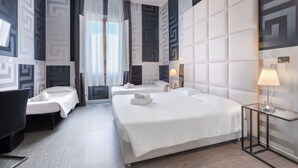 A hotel room with two beds, a desk, a chair, and a lamp. - Hotel Argentina (Florence)