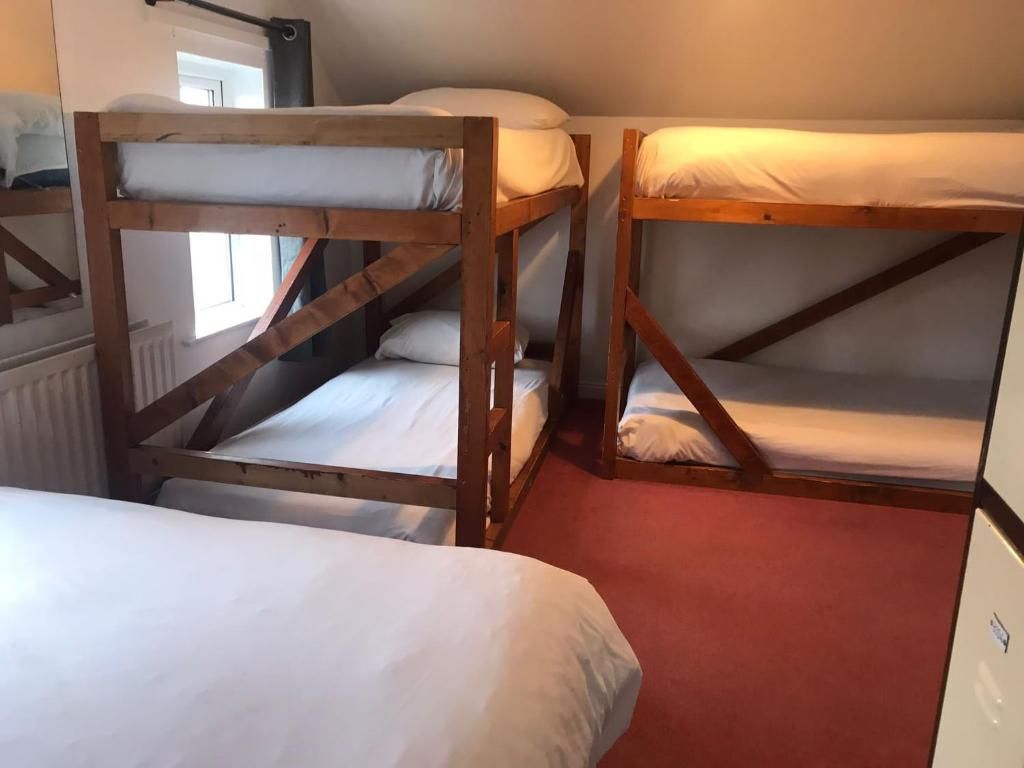 A room with bunk beds and a radiator.