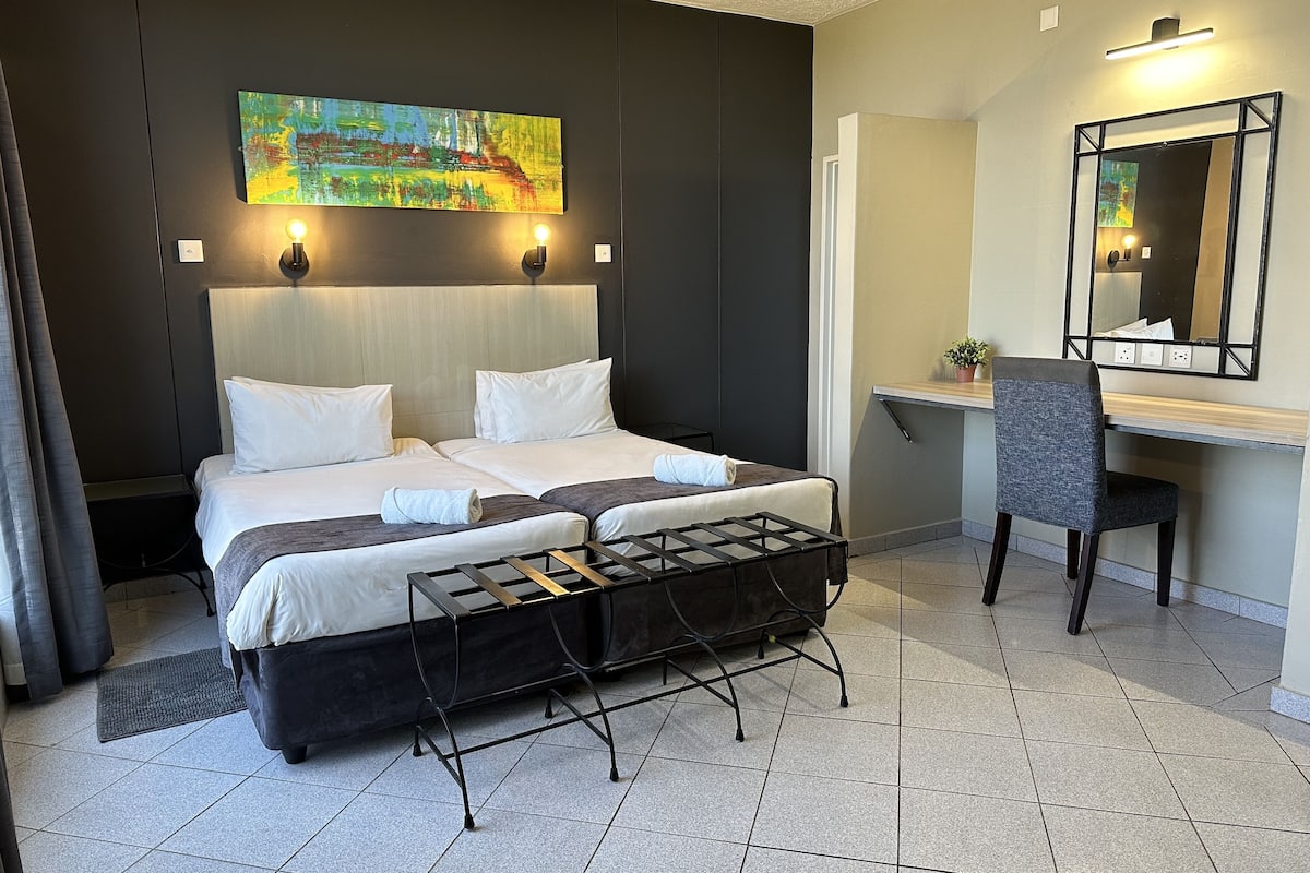 standard twin room | in-room safe, desk, laptop workspace, blackout curtains