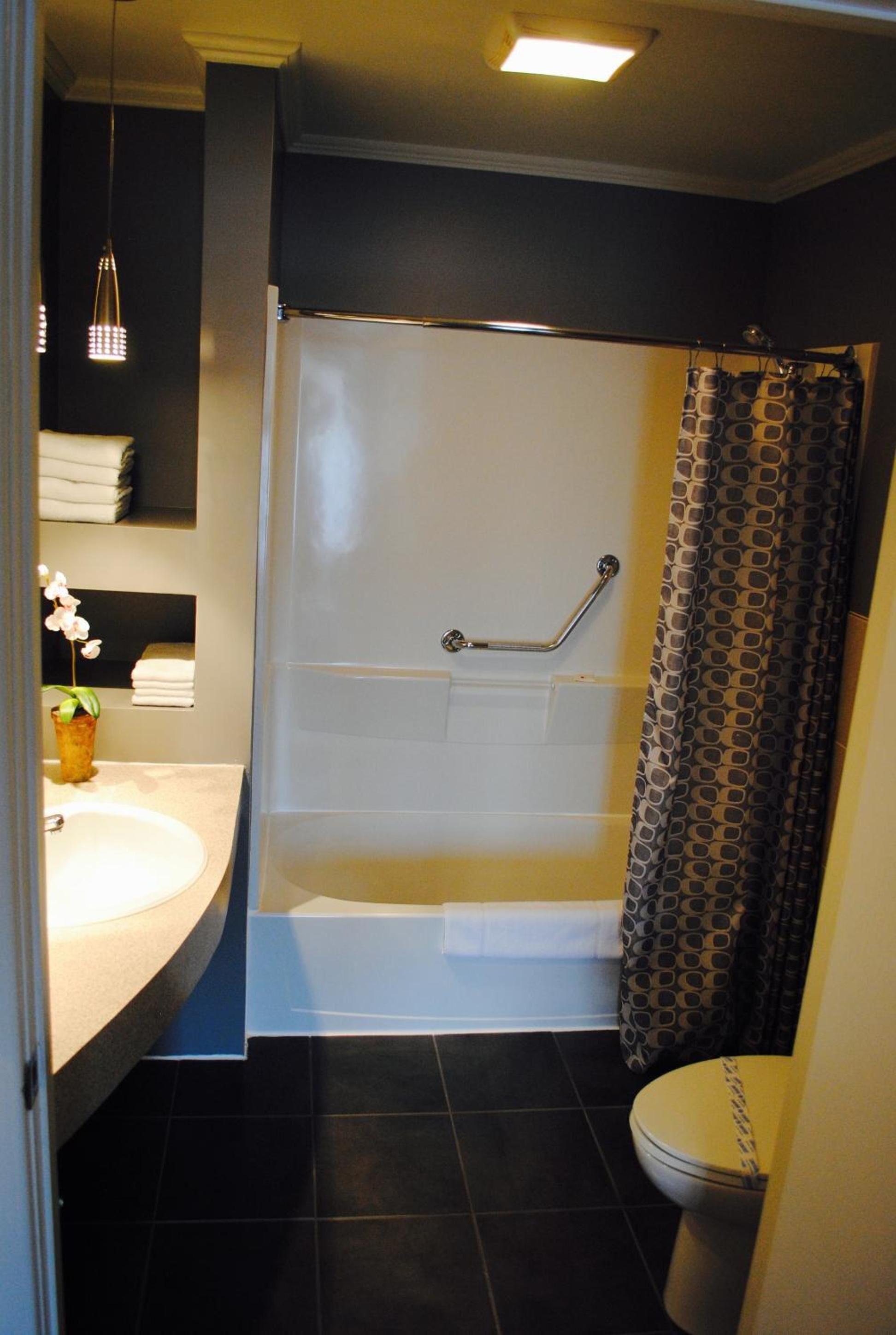 A bathroom with a bathtub, toilet, and sink.