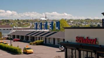 A motel with a sign reading "MOTEL" and a separate sign for "St. Hubert".