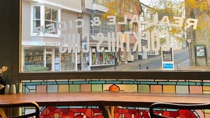 A view from inside a restaurant with a window overlooking a street. - King William IV (Totnes)