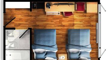 A room with two beds, a desk, a chair, a red chair, a small table, and a window.