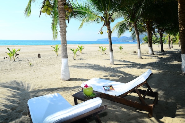 On the beach, sun-loungers