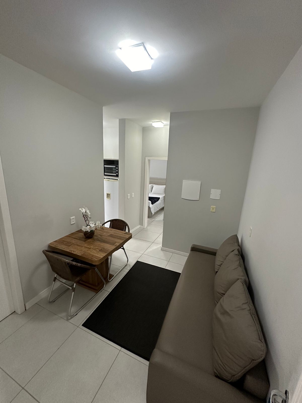 A compact living space with a kitchenette, a dining area, and a seating area.