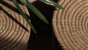 A close-up of woven baskets with a dark background. - Maui Garden Oasis (Lahaina)