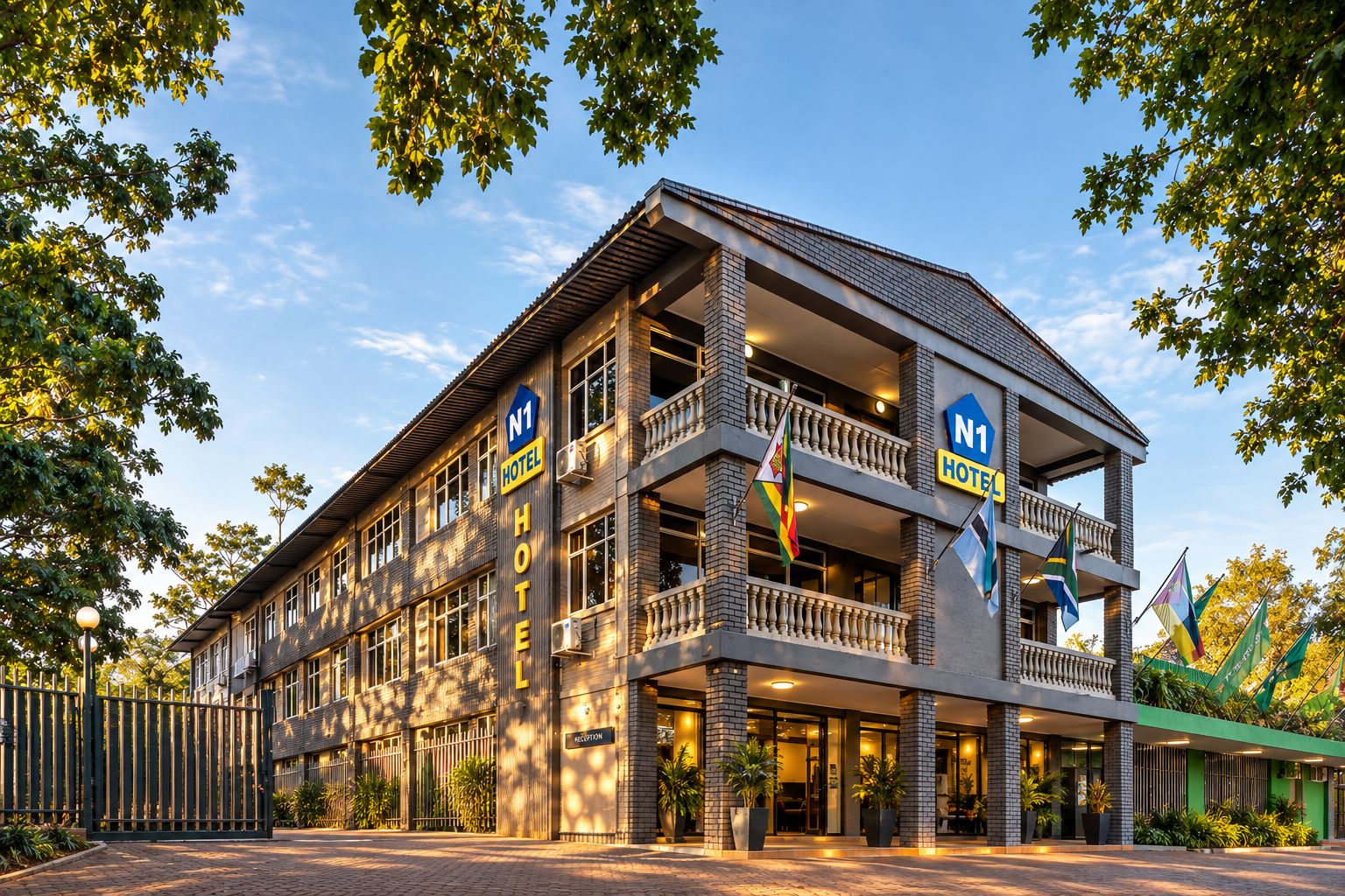 A hotel with a reception area, multiple balconies, and flags.