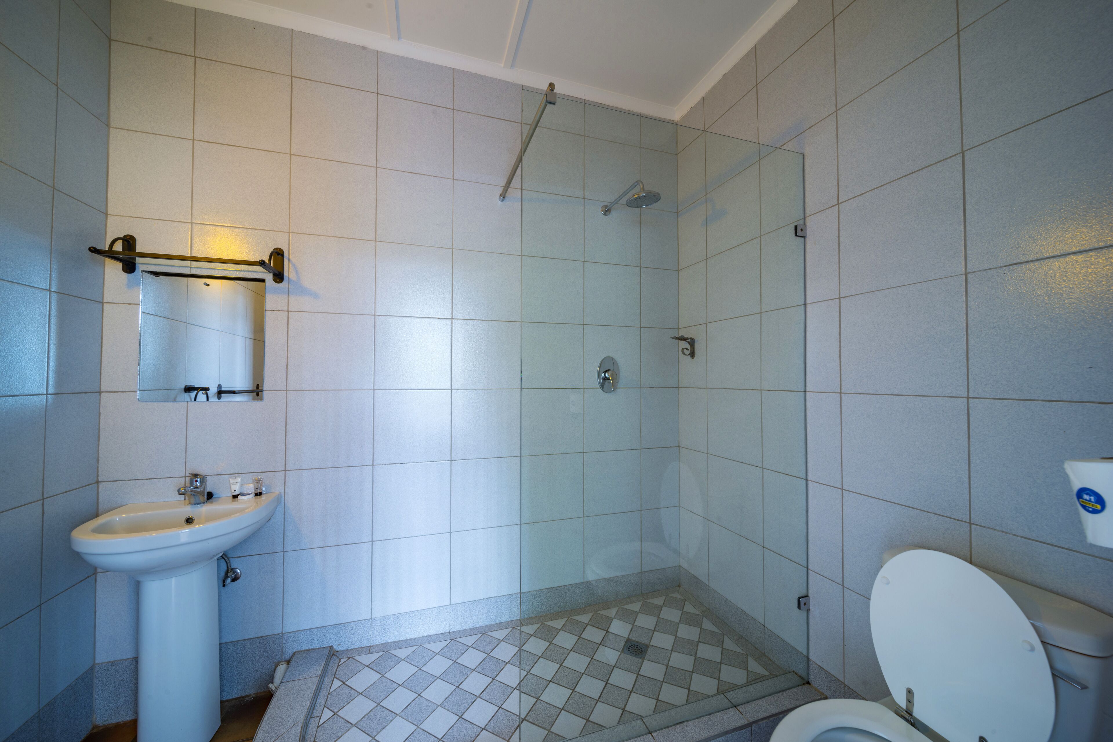 A bathroom with a sink, toilet, and shower.